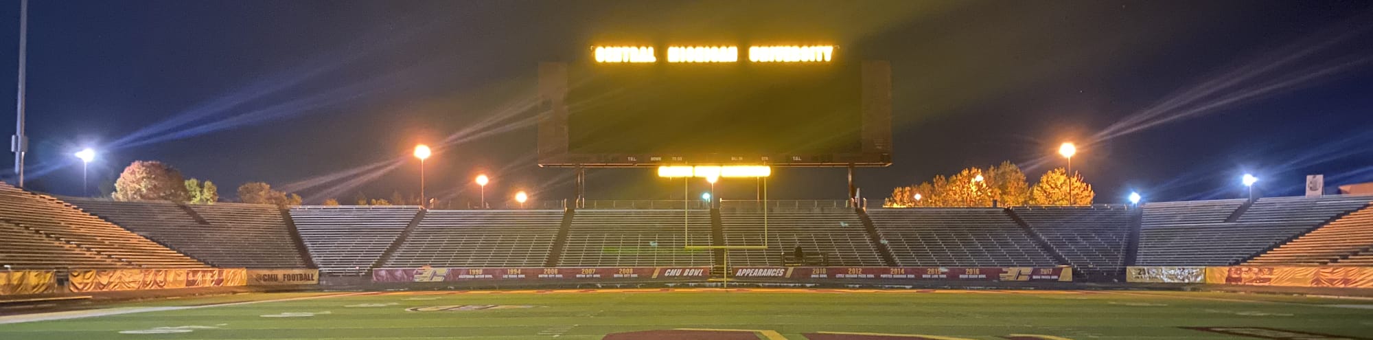 empty football stadium at night under the lights Fort Collins